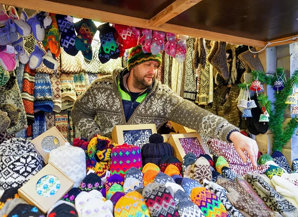 Man selling warm clothes at Riga Christmas Market