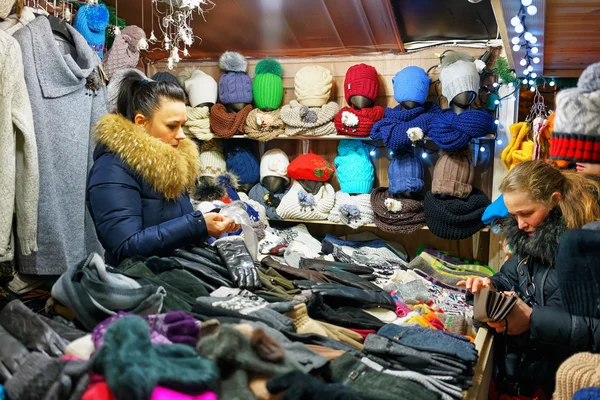 Woman selling various warm clothes at Vilnius Christmas Market