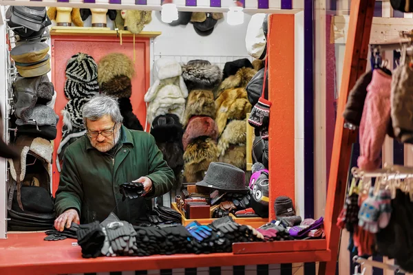 Street trader selling fur clothes in Riga Christmas Market