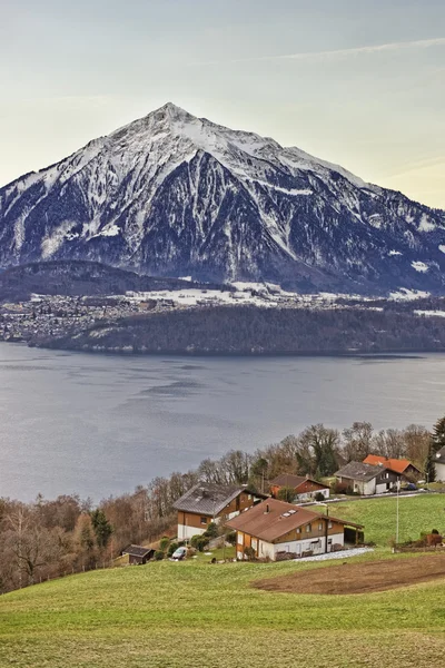 Panoramic view of Swiss Niesen mountain near the Thun lake in wi