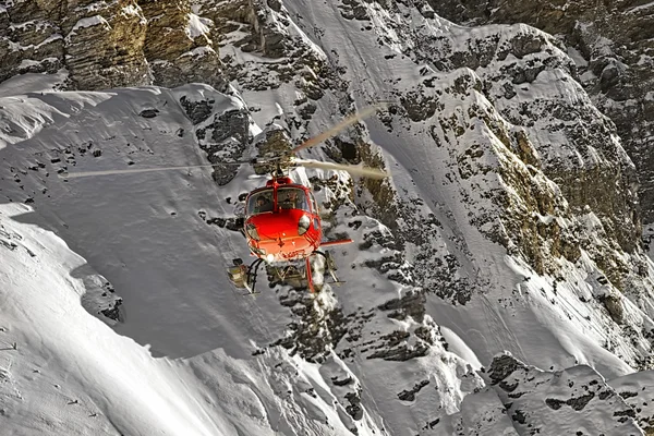 Red helicopter at swiss alps
