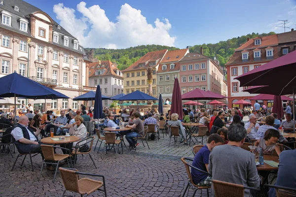 People in outdoot cafe on central square in Heidelberg