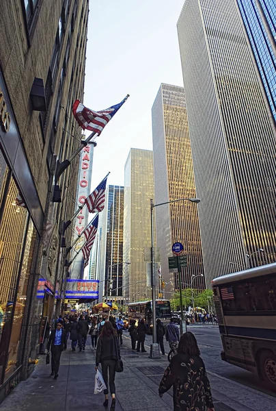 People walk past Radio City Music Hall at 6th Avenue in New York