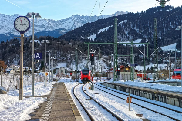 Shiny red train arriving at Garmisch-Partenkirchen railway station