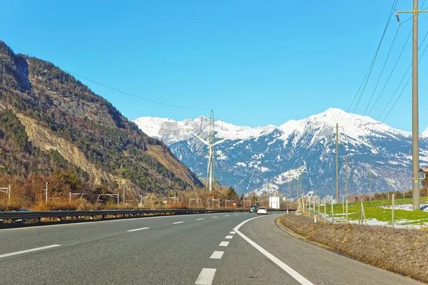 Road view on electricity transmission lines in Switzerland in wi