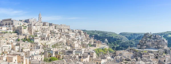 Panoramic view of typical stones (Sassi di Matera) and church of Matera UNESCO European Capital of Culture 2019 under blue sky