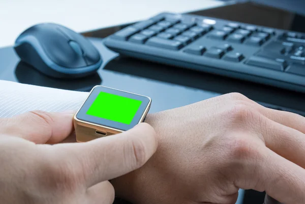Business man using his smartwatch app with chroma key green screen, new technology concept