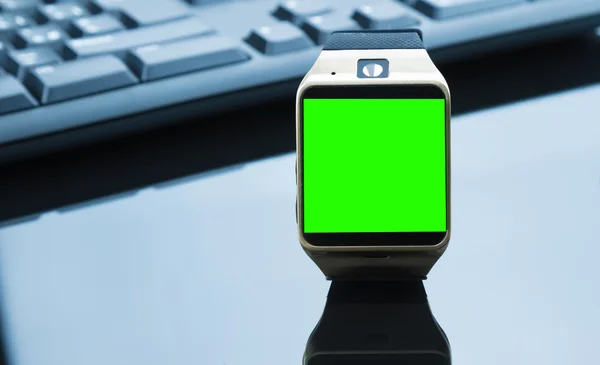 Smartwatch near computer pc keyboard and mouse with chroma key green screen