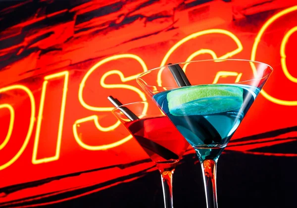 Blue and red cocktail with neon disco word background with space for text