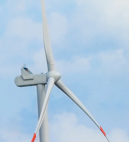 Wind energy turbines are one of the cleanest, renewable electric energy source, under blue sky with white clouds