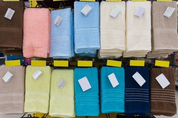 Towels Hang on Shelf in Supermarket or Hypermarket with Blank Ta
