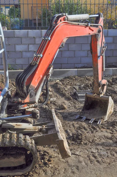 Excavator digging a hole