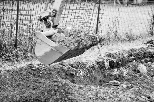 Excavator digging a hole