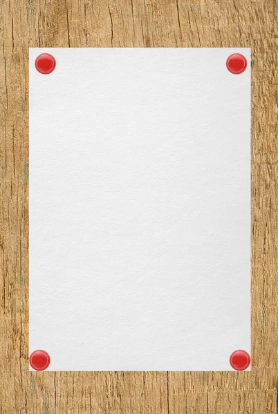 White sheet of paper attached on wooden background