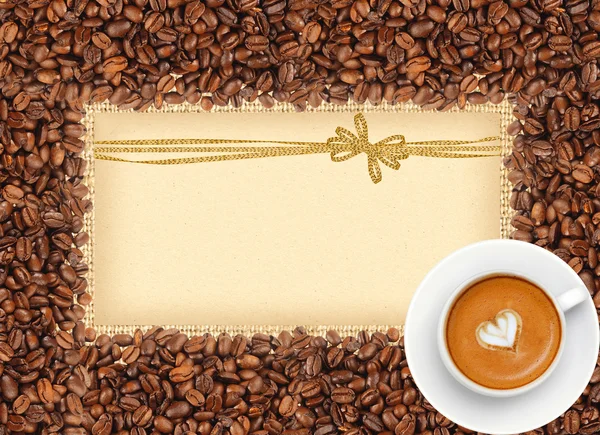 Coffee beans frame over burlap textile with greeting card with g