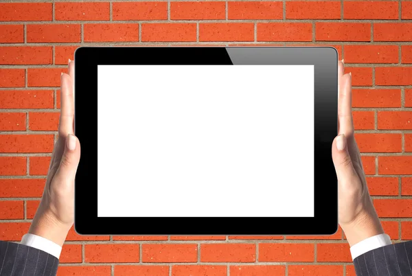 Black Touch Screen Tablet in woman hands over orange brick wall