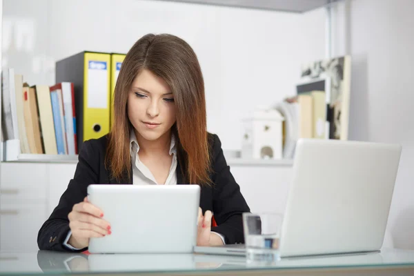 Businesswoman using tablet computer in office building,