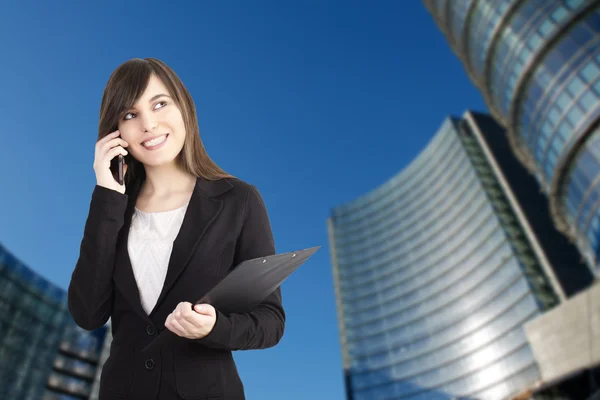 Young businesswoman working outside office building