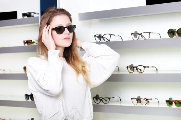 Young woman posing in optical store