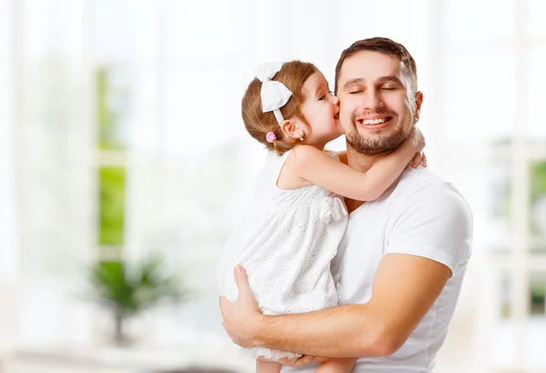 Happy family and father's day. daughter kissing and hugging dad