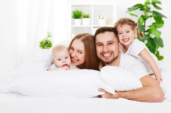 Happy family at home in  the bed