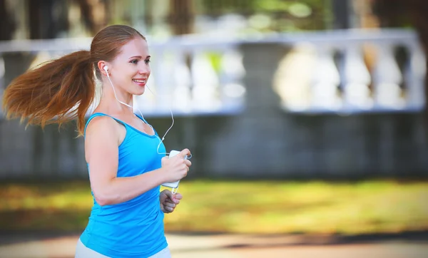 Happy girl runner in for sports and fitness runs in summer in pa