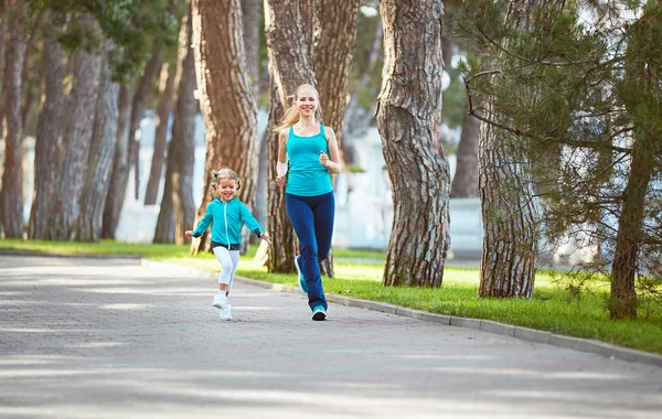 Sports family mother and child daughter are engaged in running a