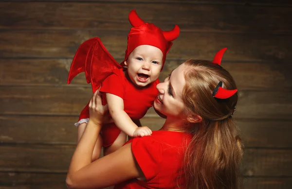 Family mother and baby son celebrate Halloween in devil costume