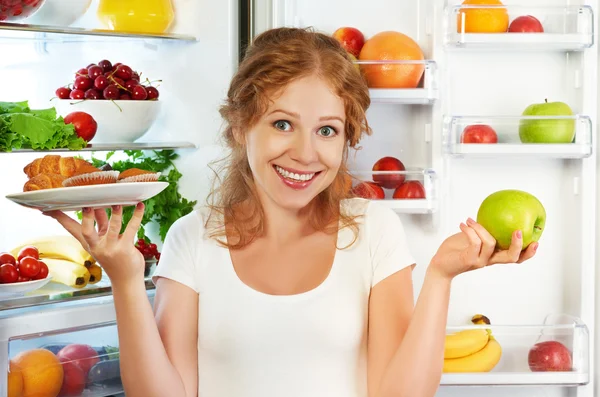 Woman on diet to choose between healthy and unhealthy food near