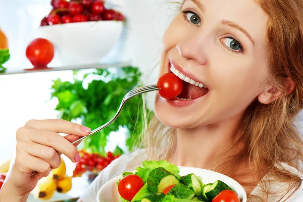 Woman eats healthy food vegetable vegetarian salad about refrige