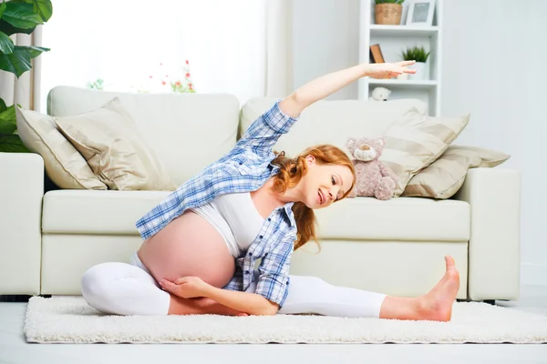 Pregnant woman practicing yoga and fitness at home