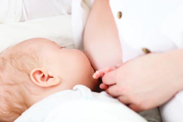 Breastfeeding. mother holding newborn in embrace and breastfeed