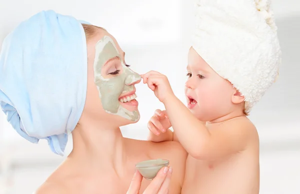 Family beauty treatment in  bathroom. mother and daughter baby g