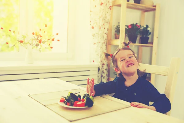 Child girl does not like and not want to eat vegetables