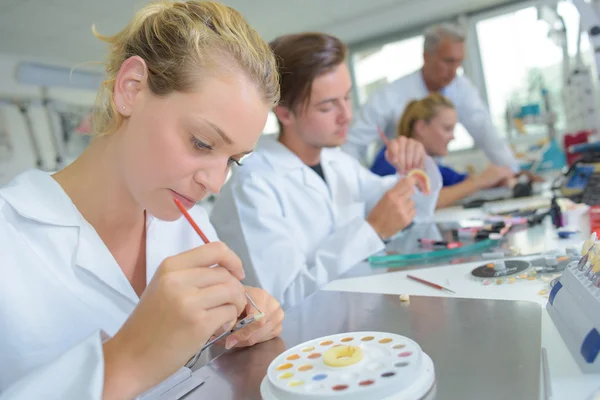 Woman in prosthetics lab preparaing paint