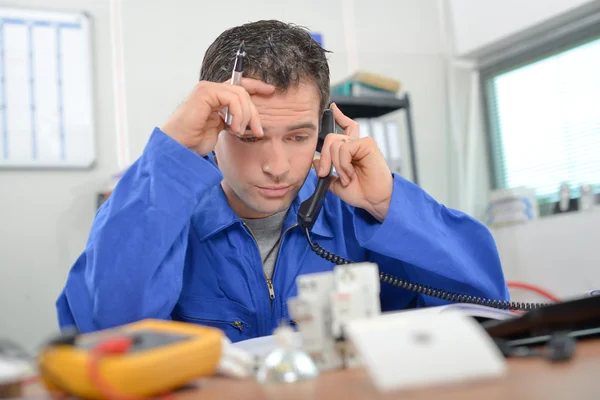Stressed worker on telephone