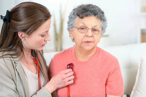 Checking senior woman s heartbeat