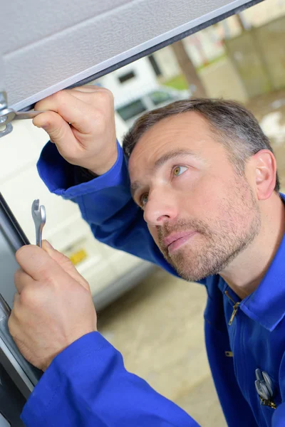 Man installing a garage door