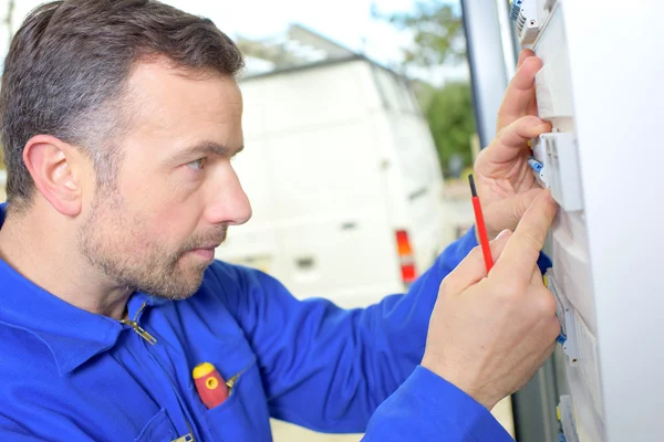 Handyman working on a fusebox