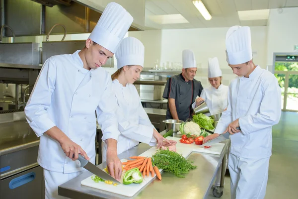 Chef supervising team of trainees