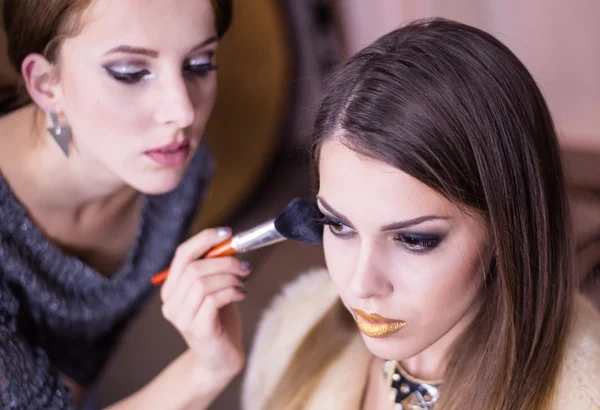 Artist Applying Make up to Pretty Female Model