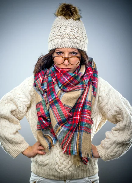 Grumpy young woman in winter fashion