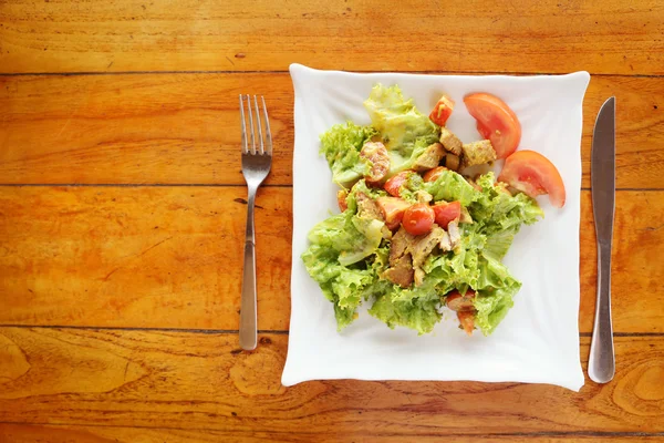 Summer lunch - chicken caesar salad on the white plate