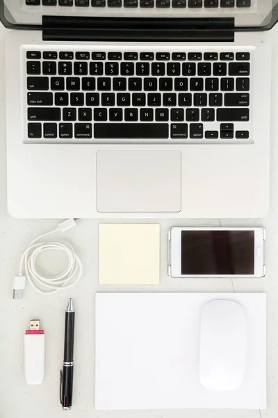 Top view on working desk with laptop and office equipment