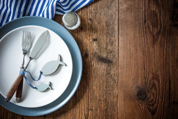 Sea food place setting on wooden table with copy space