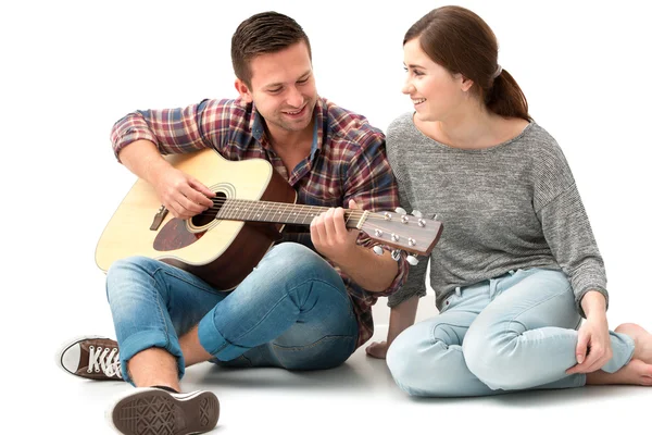 Young couple playing guitar
