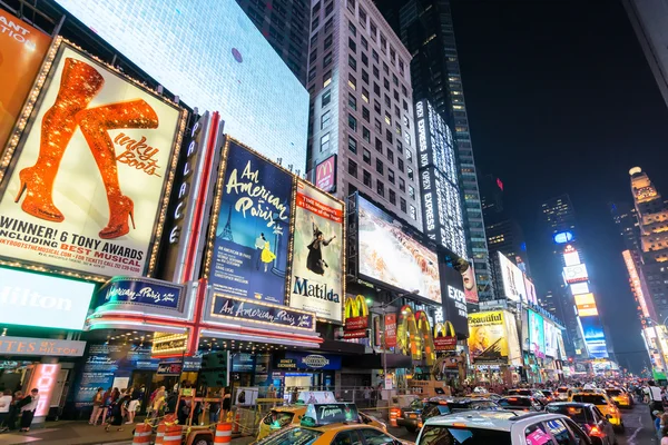 NEW YORK CITY - JUNE 12, 2015: Times Square at night featuring lighted billboards of the broadway best show