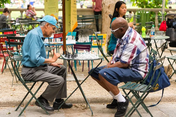 NEW YORK CITY - JUNE 17: People playing chess in bryant park. The Chess Area provides the public with an opportunity to play chess and backgammon for free. June 17, 2015 in Manhattan, New York City.