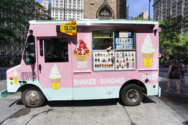 Pink ice cream truck delivering sundaes and cones on the streets of Manhattan, in New York City