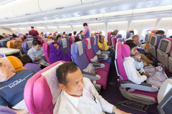 BANGKOK, THAILAND - OCTOBER 27: flight crew and passengers on bo